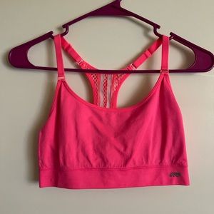 Hot pink sports bra with white detail on back